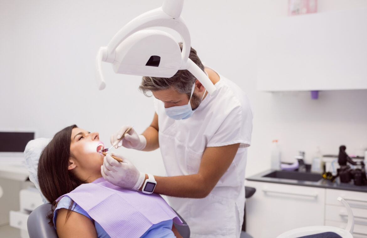 dentist examining female patient teeth 1